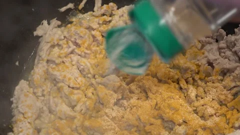 Adding Garlic Salt And Paprika To Meat Cooking In Fryer Stock-Footage 246869360