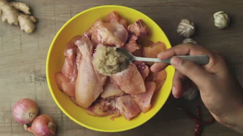 Adding ginger garlic paste into the chicken marination before cooking, Video stock 139261778