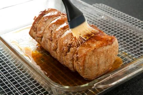 Adding Glaze to a Pork Loin with a Basting Brush Stock Photos