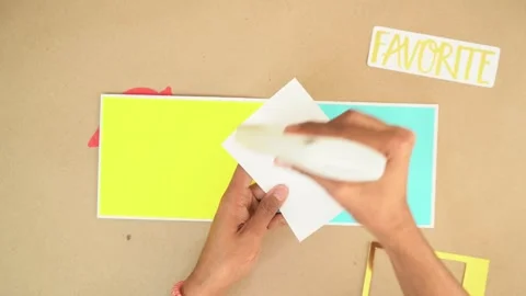 Adding glue to piece of design cardstock for creative project Stock Footage 289564005