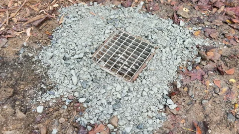 Adding a grate to cover water shut off Stock Footage 332542437