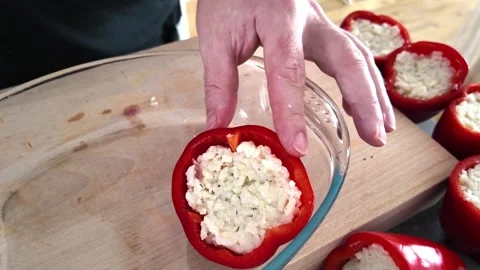 Adding grated Gruyere cheese to stuffed red pepper Video stock 345081761