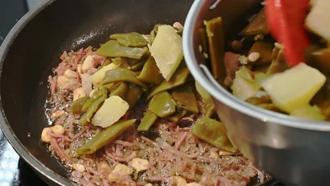 Adding green beans to cooked potatoes Stock Footage 219875608