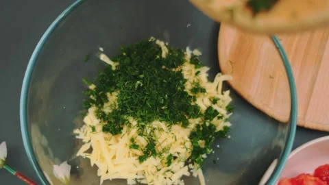 Adding green dill to yellow cheese Video stock 252356037