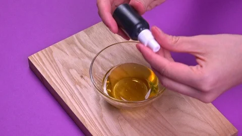 Adding green dye to honey and stirring, close-up Stock Footage 126213948