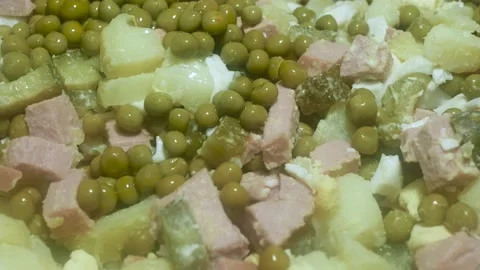 Adding green peas and carrots to a salad of short sausage and pickled cucumb 스톡 동영상 229645462