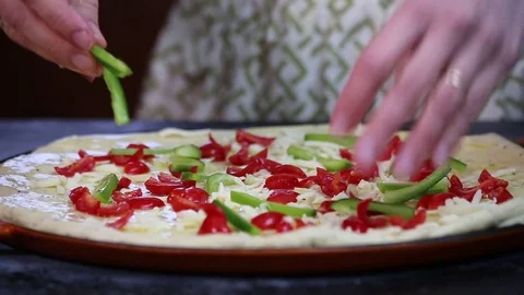Adding green peppers to a home made pizza Stock Footage 73738077