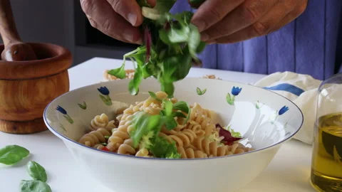 Adding green sprouts to a whole wheat pasta salad. Stock Footage 195950942