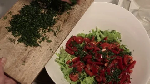 Adding greens to salad Stock Footage 72228428