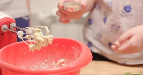 Adding ground cinnamon to dough in mixing bowl Stock Footage 105785091