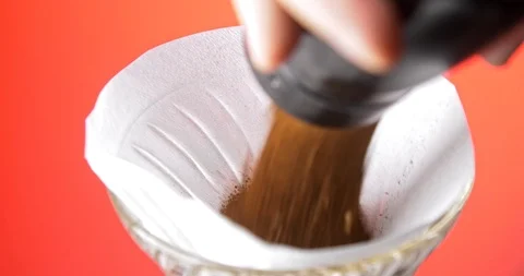 Adding ground coffee into pour over paper filter Stock Footage 122178282