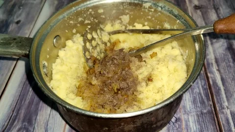 Adding ground pepper to boiled mashed potatoes and mixing with a pusher Stock Footage 232219201