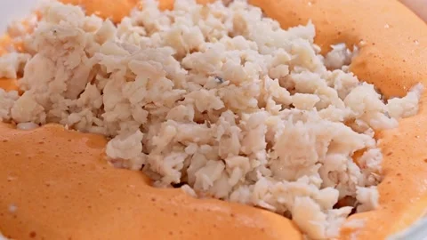 Adding the hake to prepare the pudding Stock Footage 228221107