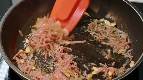 Adding ham to fry and give it a good flavor Stock Footage 219875413