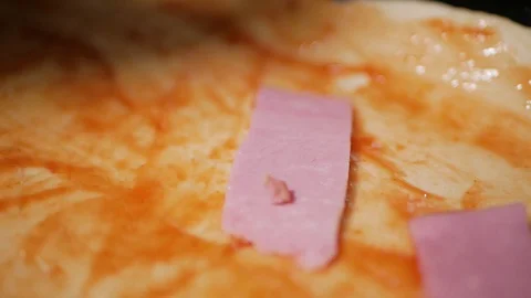 Adding ham on pizza, close up Stock Footage 128667560