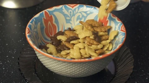 Adding healthy cereal into colorful plate for children breakfast. Stock Footage 119314811