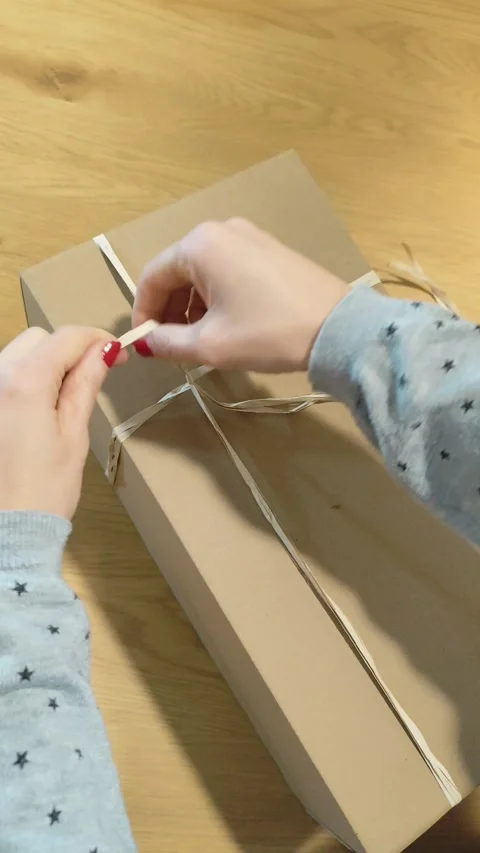 Adding a Heart-Shaped Card to a Sustainable Package Stock Footage 326066626