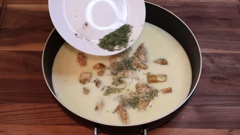 Adding Herbs and Spices to Creamy Chicken Sauce in Pan Slow Motion Stock Footage 334802874