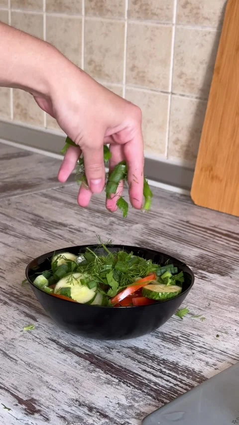 Adding Herbs to Fresh Vegetable Salad Video stock 340340871