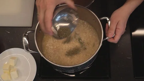 Adding herbs to rice overhead Stock Footage 112127549