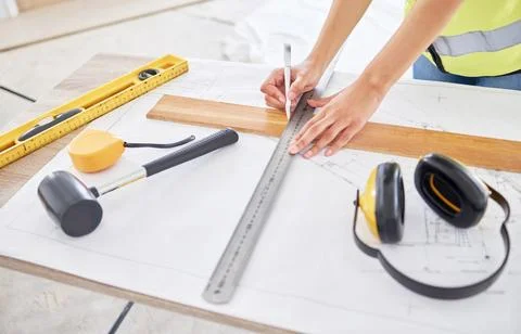 Adding a homely touch. an unrecognisable contractor standing alone inside and Stock Photos