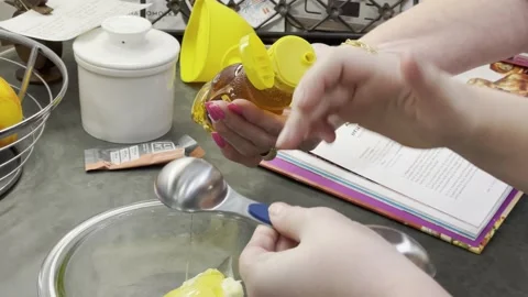 Adding honey for a recipie. Stock Footage 253344883