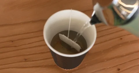 An adding hot water black tea of work tools in office Stock Footage 122090260