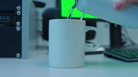 Adding a hot water to a white coffee cup sits on a desk Video stock 273307582