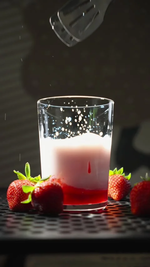 Adding Ice Cube to Strawberry Milk Drink Close Up Stock Footage 338233860