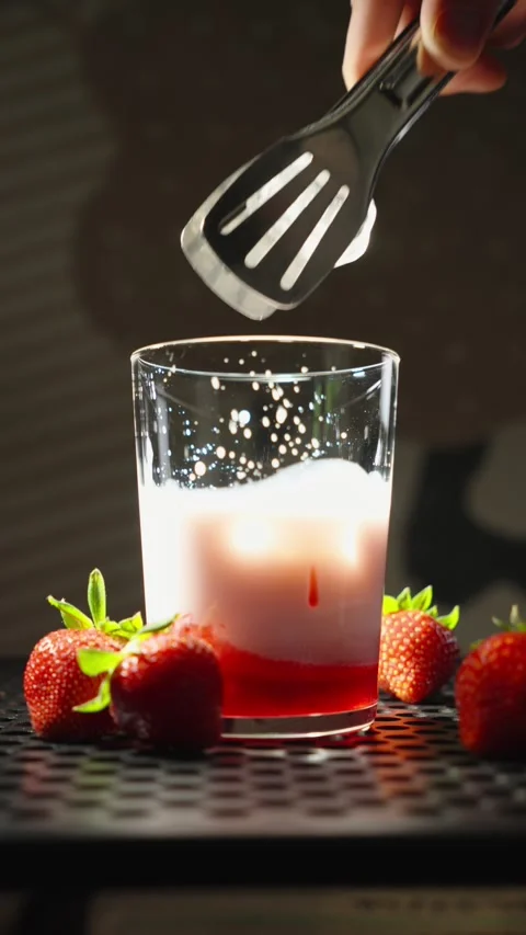 Adding Ice Cube to Strawberry Milk Drink in Slow Motion Close Up Stock Footage 338233861