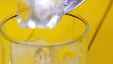 Adding ice cubes into glass outdoors Stockbeeldmateriaal 153698993