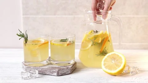Adding ice to lemonade, making a homemade cold drink Stock Footage 151076897