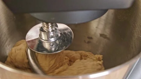 Adding ingredients to metal bowl of planetary mixer and mixing. Preparation of Stock Footage 244720626