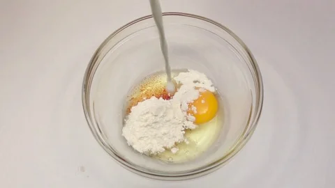 Adding ingredients to one large glass bowl in slow motion Stock Footage 76148284