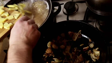 Adding ingredients for the preparation of mushroom soup in a pan. Stock Footage 102720830