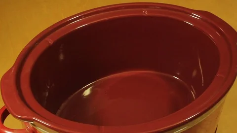 Adding Ingredients to a Slow Cooker Crock Pot Vídeo Stock 92484734