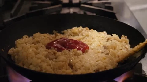 Adding Ketchup to Fried Rice in Pan Close Up Video stock 347688006