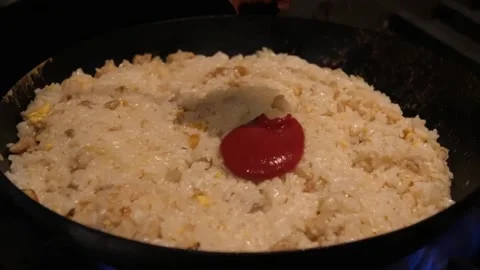 Adding Ketchup to Fried Rice in a Wok - Homemade Asian Cooking Stock Footage 347688983