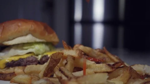 Adding ketchup to pile of fries in slow motion. Stock Footage 118046225
