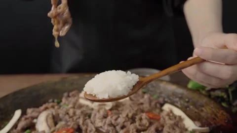 Adding Korean Bulgogi Beef over White Rice Stock Footage 334912437