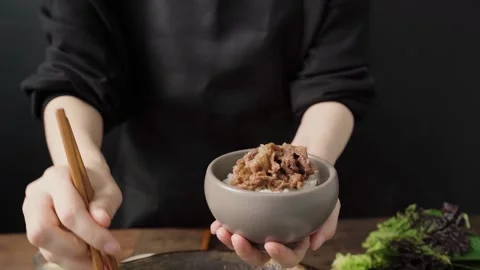 Adding Korean Bulgogi Beef over Steamed Rice Stock Footage 334912449