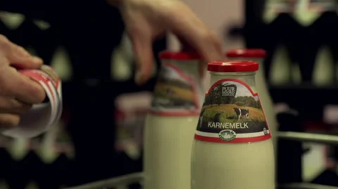 Adding labels to bottles milk Stock Footage 35178900