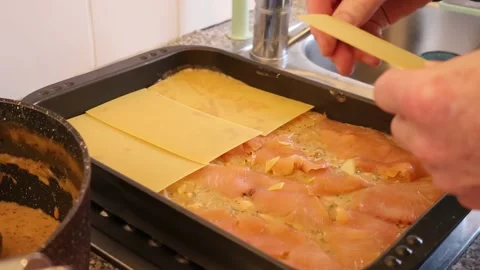 Adding lasagna sheets on top of salmon lasagna. Making homemade lasagna close up Stock Footage 233275471