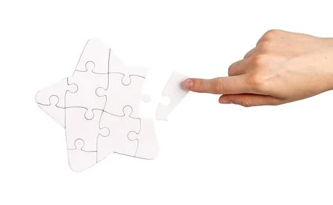 Adding last puzzle piece to complete jigsaw Stock Photos