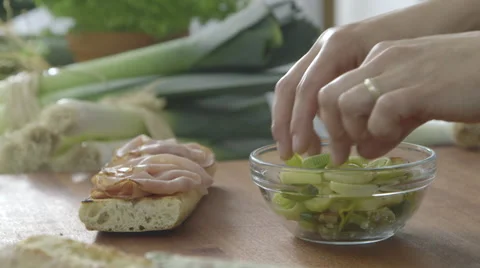 Adding leeks slices on a bread Stock Footage 63780003