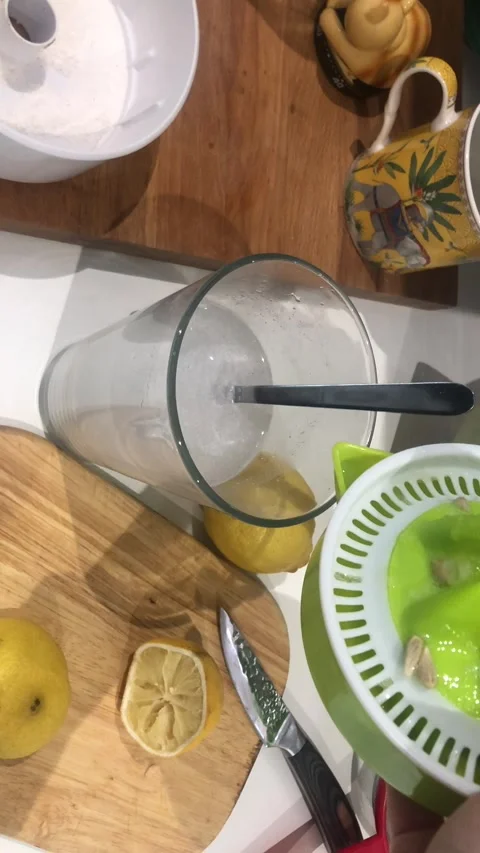 Adding Lemon Juice To Drink In Kitchen Setting Close-Up Stock-Footage 333062923