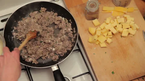 Adding Liquid to meat dish Stock Footage 25619839