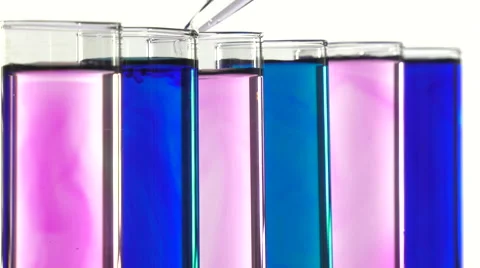 Adding liquid with a pipette into test tubes blue and pink Video stock 64292637