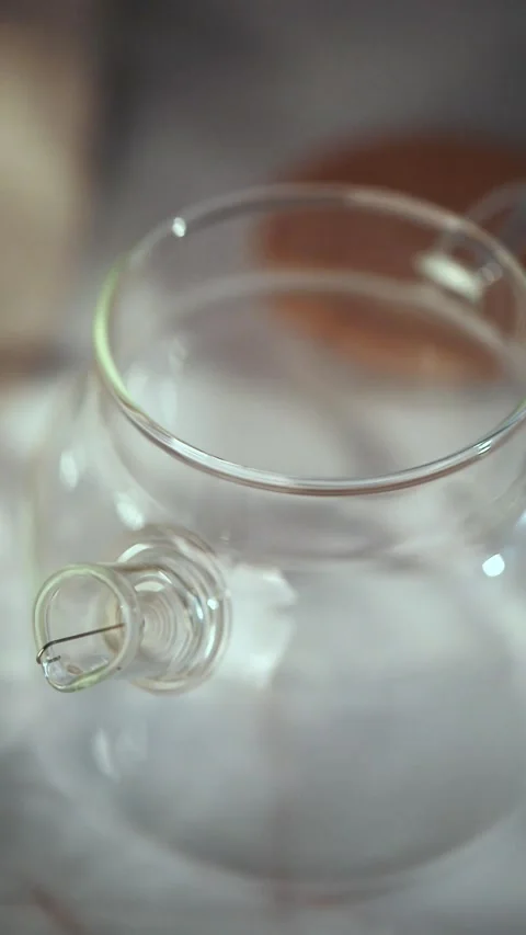 Adding Loose Tea Leaves to Glass Teapot Stock Footage 344042080
