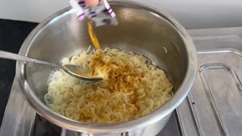 Adding Maggi Masala into Noodles | Mixing Spice Powder Stock Footage 319115287